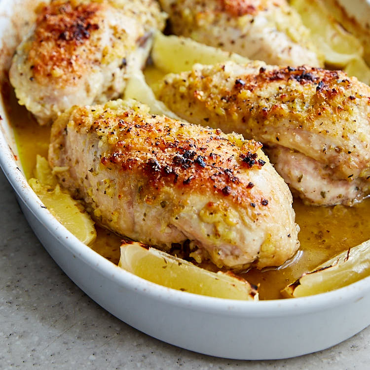 Close up of lemon garlic chicken in a baking dish.