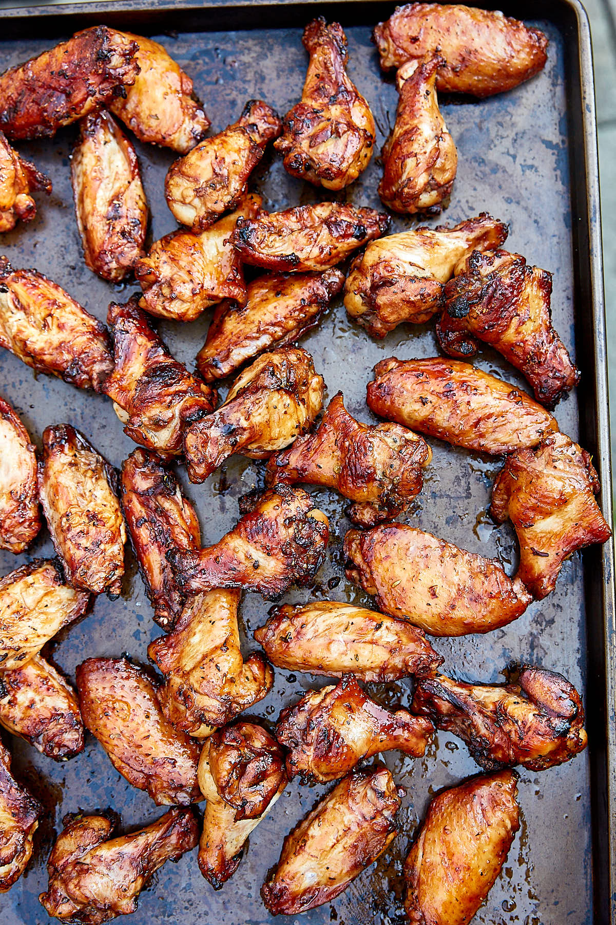 Grilled chicken wings on a large serving tray.