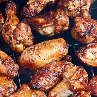 Irresistible, smoky, crispy charcoal grilled chicken wings. Marinated in olive oil, herbs and soy sauce. Lip-smacking delicious! The best grilled chicken wings. Period. | ifoodblogger.com #wings #chickenwings #grilledwings #grilledchickenwings