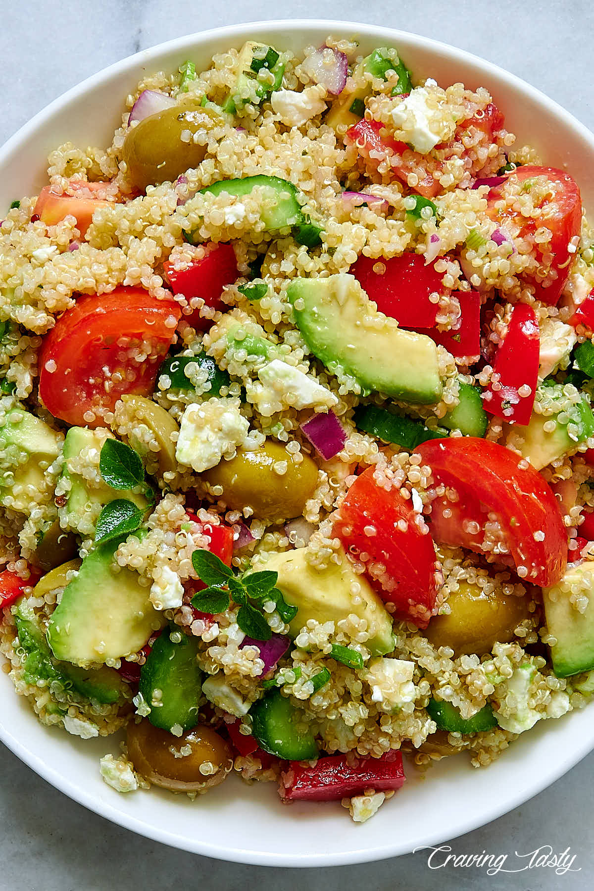Mediterranean quinoa salad on a white plate.