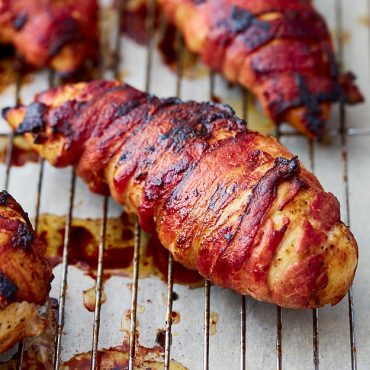 Super crispy bacon-wrapped chicken breast baked in the oven. To get the bacon super crispy use this little trick and you will love the results. Crispy bacon on the outside and tender and juicy chicken on the inside. Pure goodness!