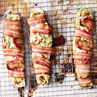 Chopped vegetables and cream cheese stuffed zucchini boats, wrapped in bacon and baked to perfection - tender, moist interior wrapped in crispy bacon.