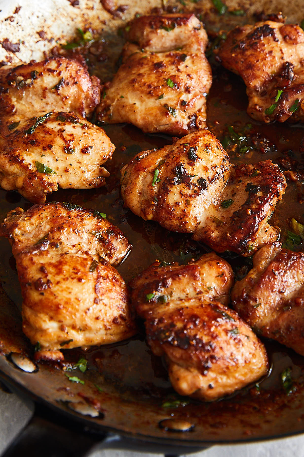 Delicious, crispy and juicy fried chicken thighs in a pan.