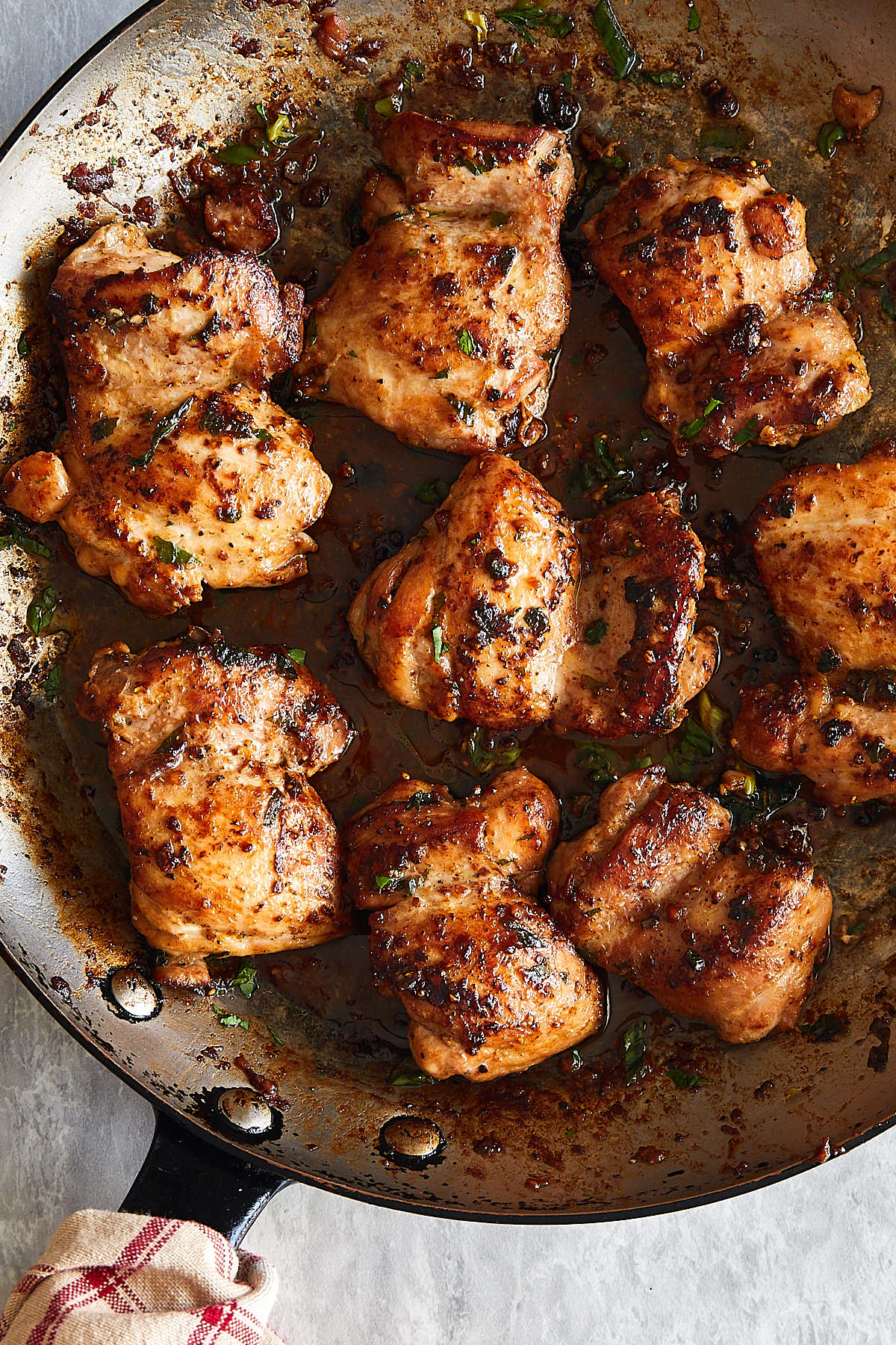 Golden brown, crispy boneless chicken thighs in a frying pan.