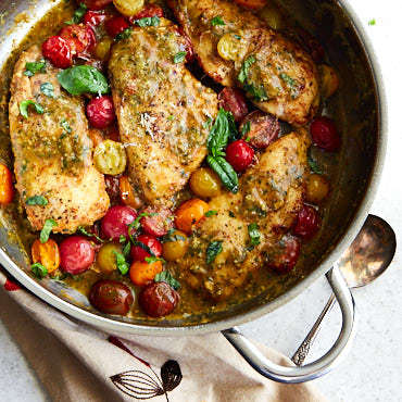 Quick pan-fried Pesto Chicken, smothered in a velvety-smooth basil sauce! Joined by colorful and delicious cherry tomatoes for extra depth of flavor. Topped with grated Parmesan cheese and fresh basil, this chicken is lip-smacking good!