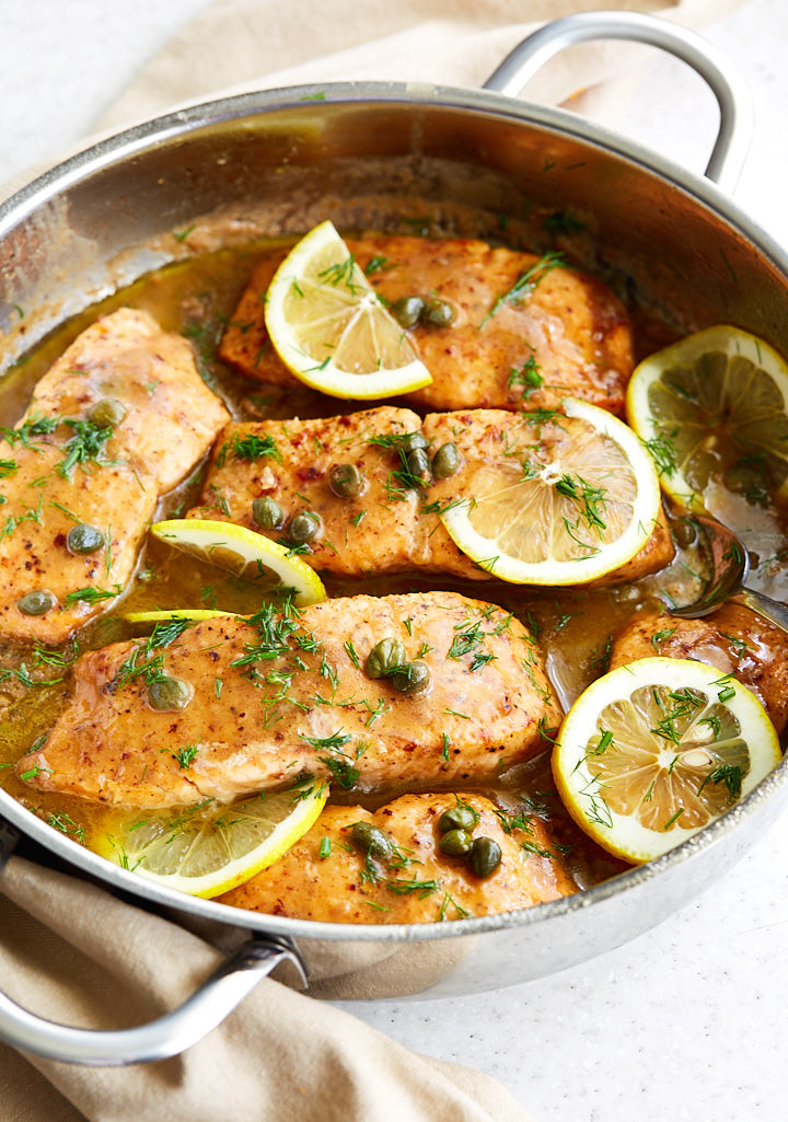 Salmon piccata in a frying pan.
