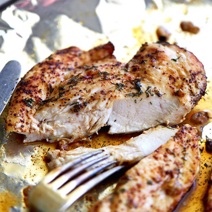 Broiled chicken breast, cut in half, juicy and succulent.