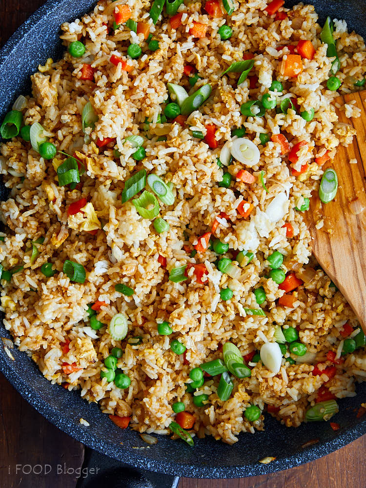 Delicious looking Japanese fried rice in a large wok with a wooden spatula.