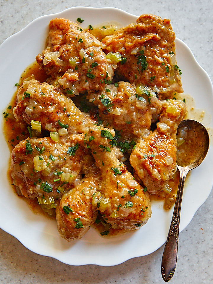 Smothered chicken on a plate.