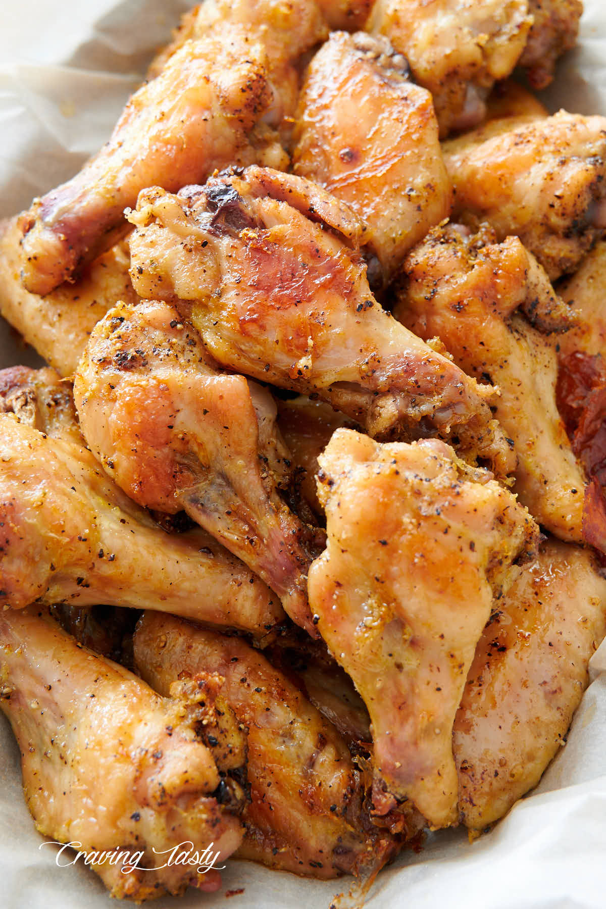 Close up of lemon pepper chicken wings in a basket, ready to serve.