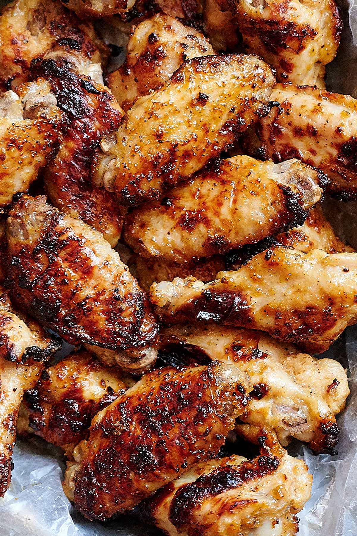 Close up of golden brown, crispy broiled chicken wings.