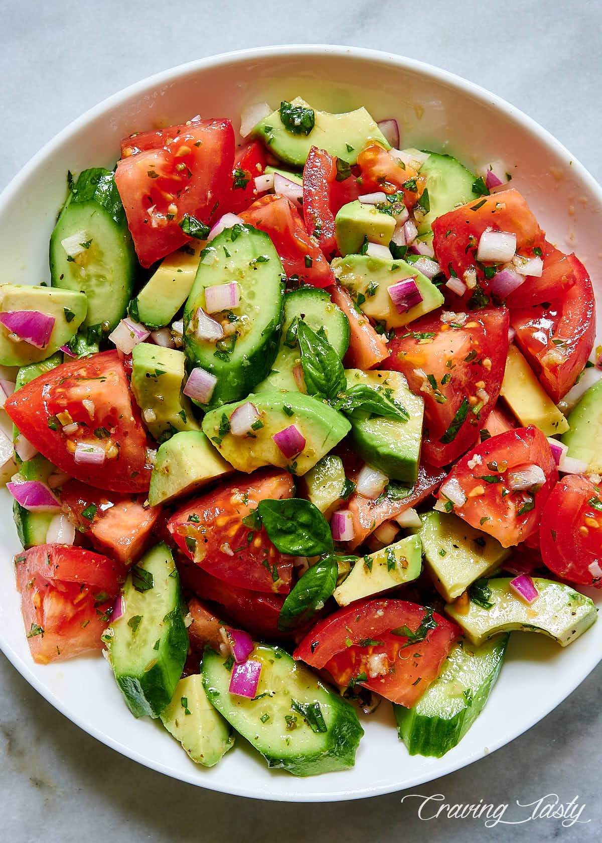 Tomato, Cucumber and Avocado Salad in a white bowl.