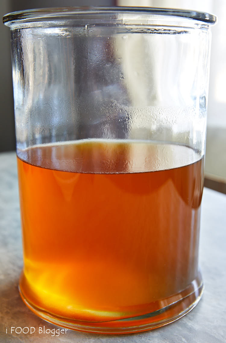 Amber Beef Consomme degreased in a glass jar.