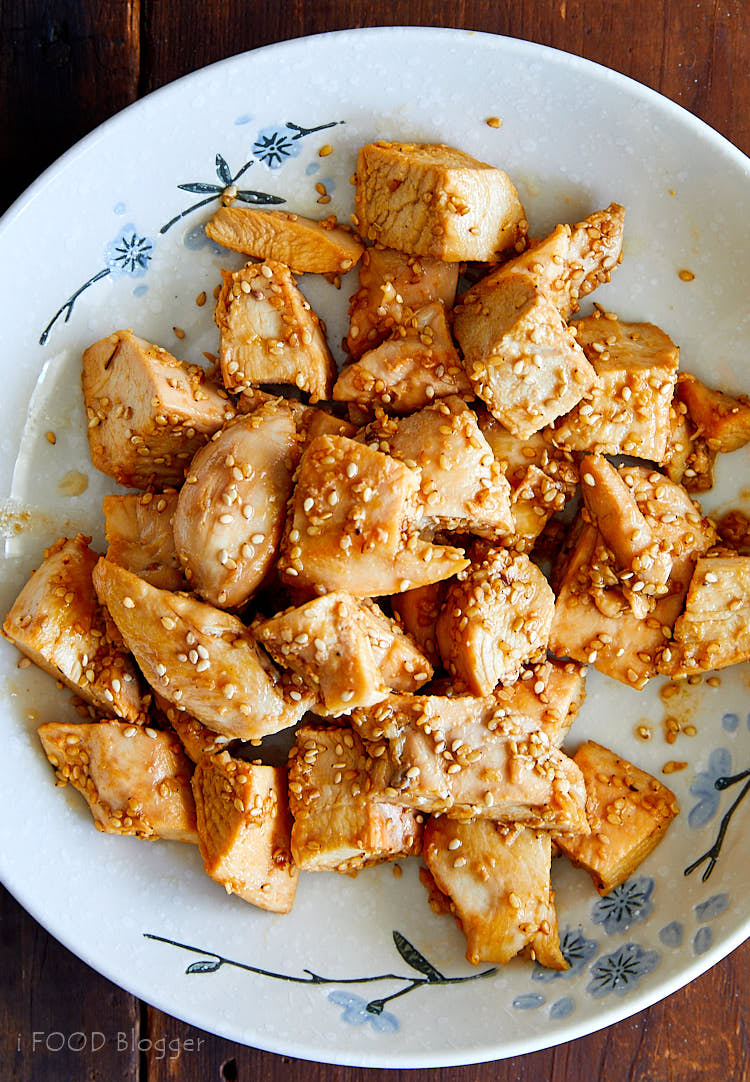 A top down view of a white plate with hibachi chicken pieces.