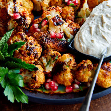 Crispy Roasted Cauliflower with Tahini Sauce and Pomegranate Molasses. You won't find a better tasting cauliflower than this. A must try! | ifoodblogger.com