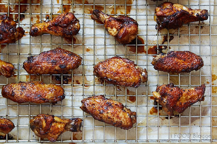 Chicken wings reheating on a baking sheet.