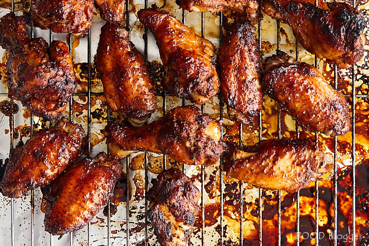 Chicken wings on baking sheet fitted with a cooling rack.