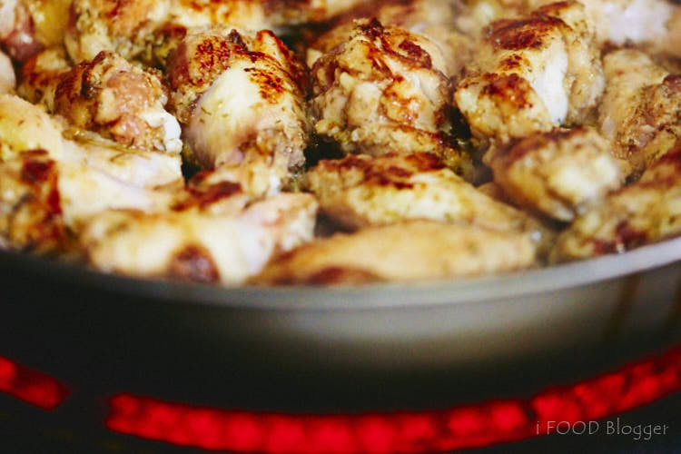 Chicken wings on a frying pan.