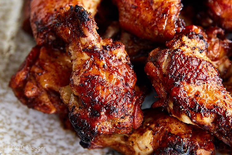 Chicken wings, golden-brown, on a plate.