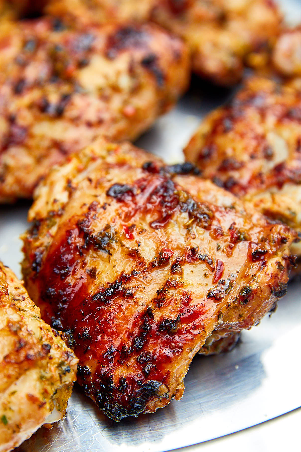 Close up of a very nicely browned grilled chicken thigh.
