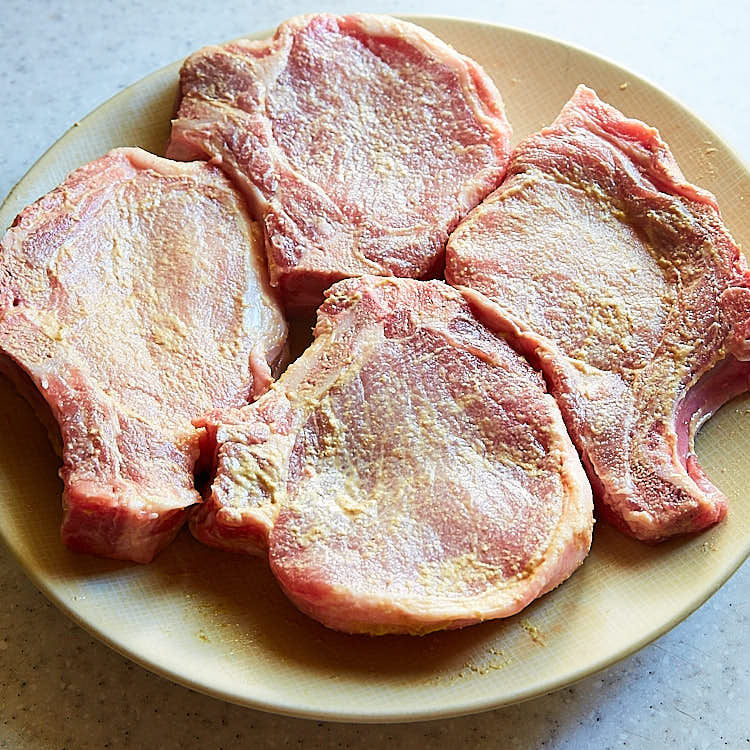 Southern Fried Pork Chops - Step 1 - Rub Mustard { ifoodblogger.com