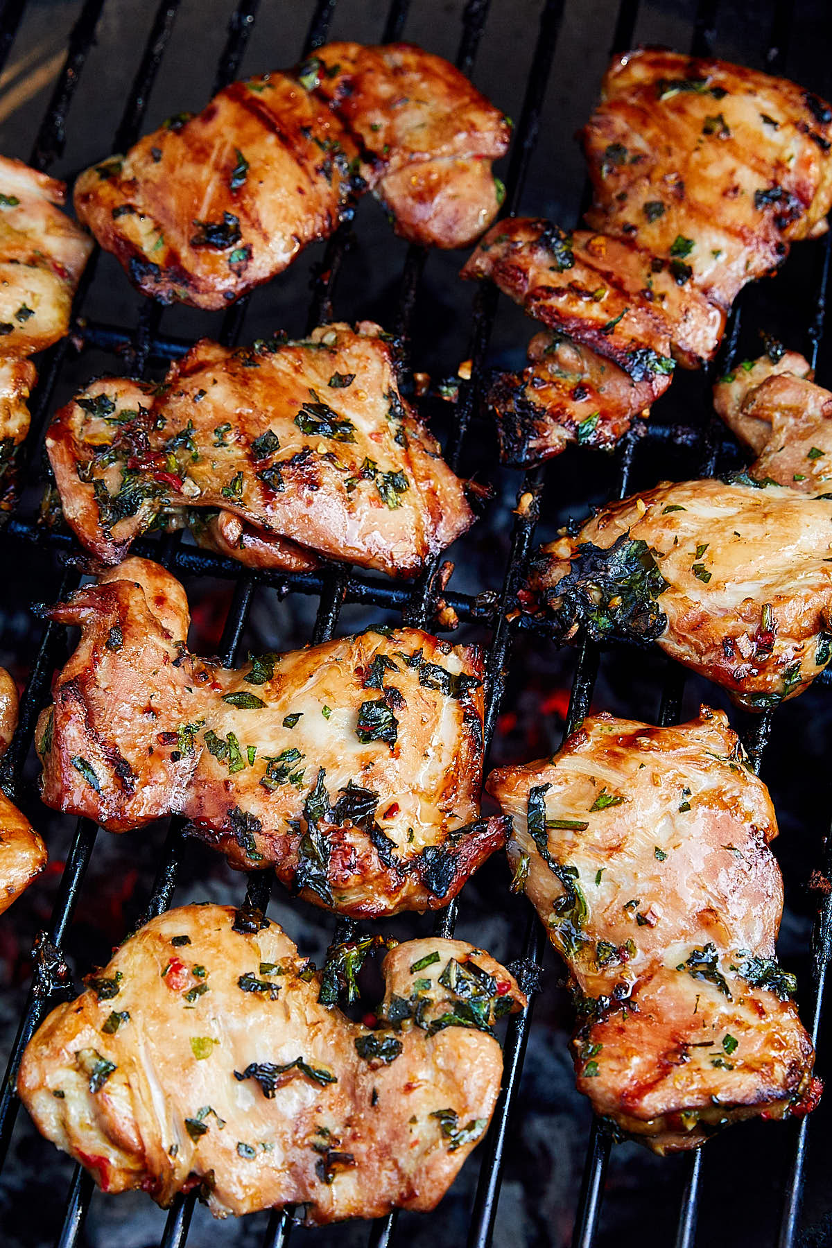 Marinated in Thai marinade, chicken thighs on a grill.