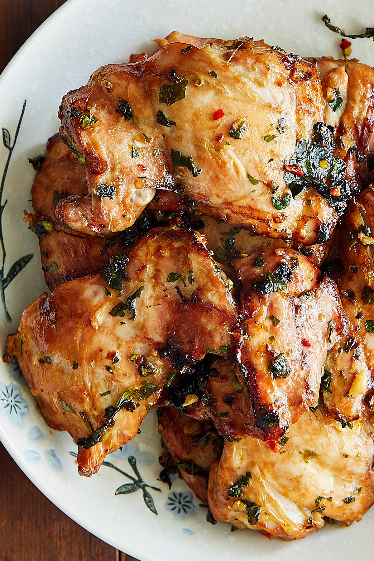 Golden brown chicken, marinated in Thai marinade, on a serving plate.