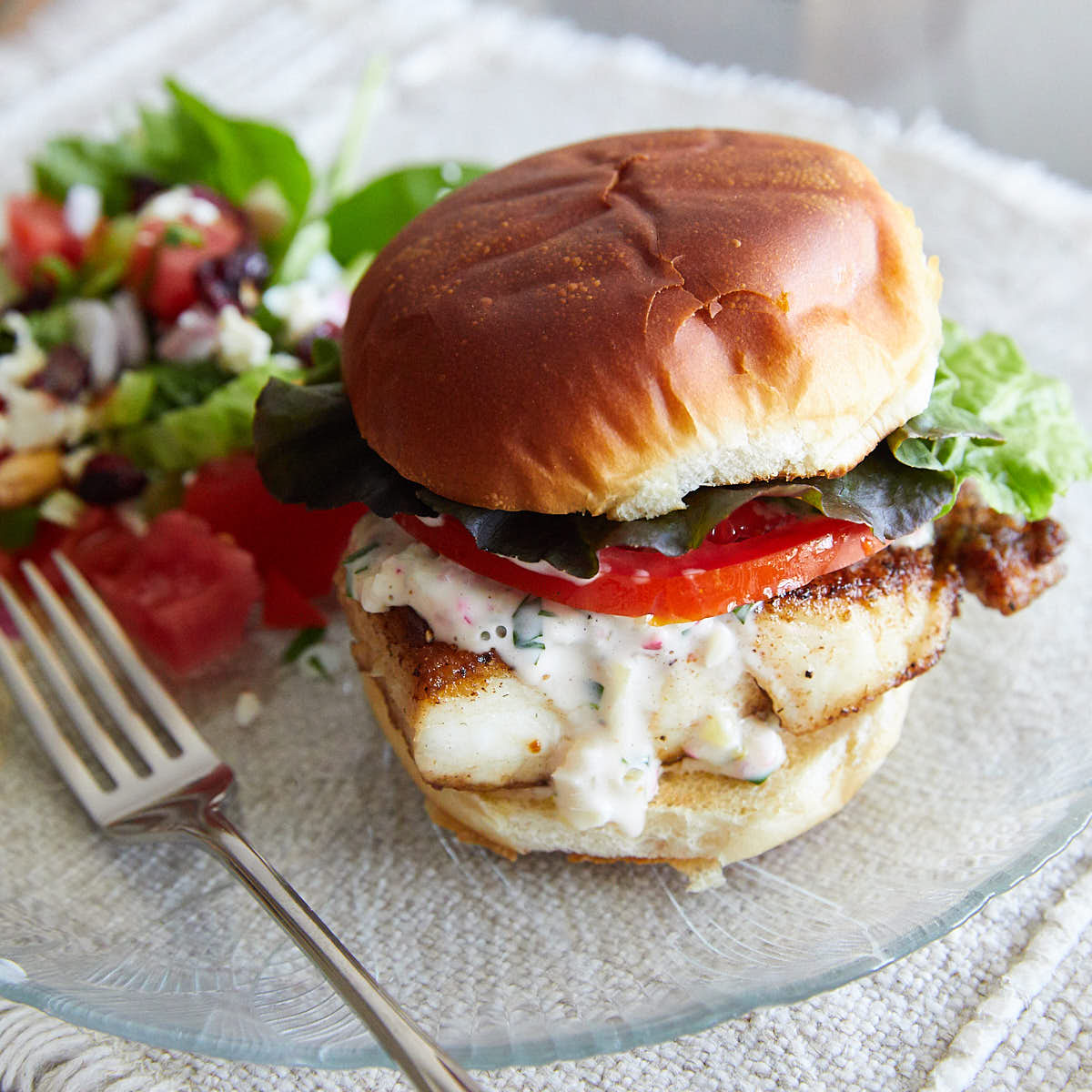 Fried Fish Sandwich with Savory Tartar Sauce on a plate.