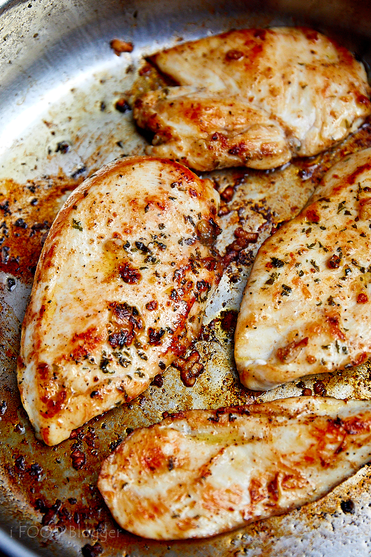 Close up view of well-browned, juicy pan-fried chicken breasts.