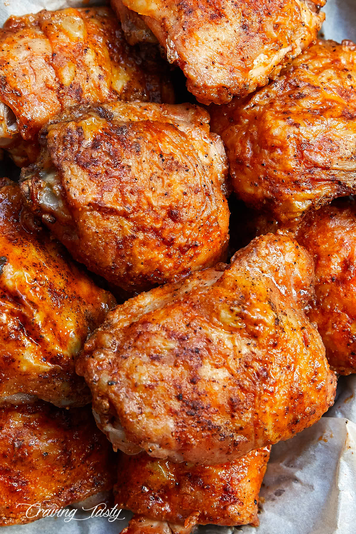 Top down view of golden brown, crispy chicken thighs.