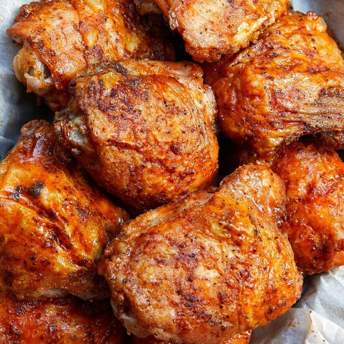 These oven-fried chicken thighs are extra crispy on the outside and very tender and juicy on the inside. There isn't a more succulent baked chicken thigh than this. They are like deep-fried chicken thighs, only without a mess and all the added calories. Oh, and they only take about 30 minutes to bake. | ifoodblogger.com