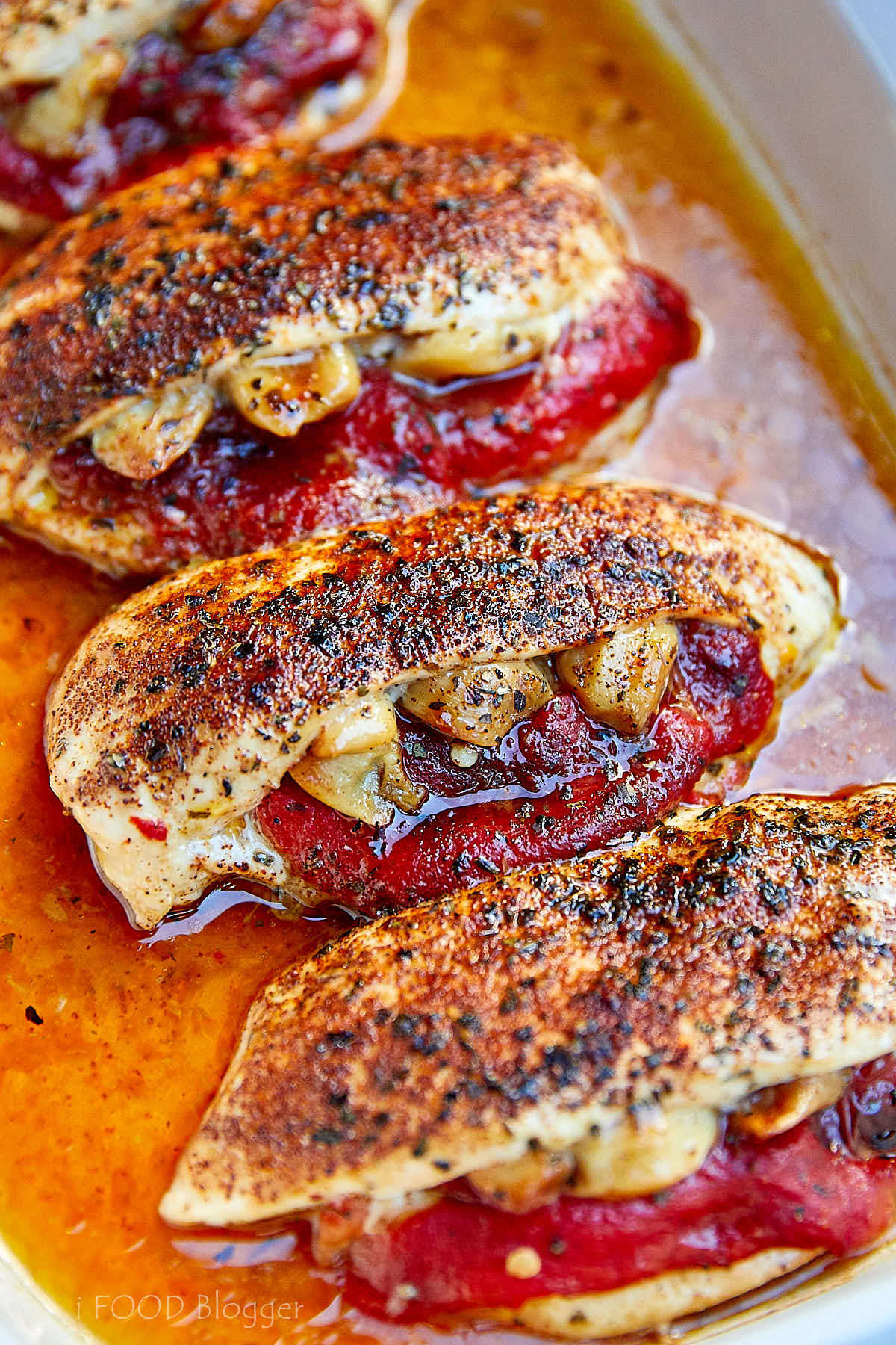 Baked stuffed chicken breasts in a baking dish.