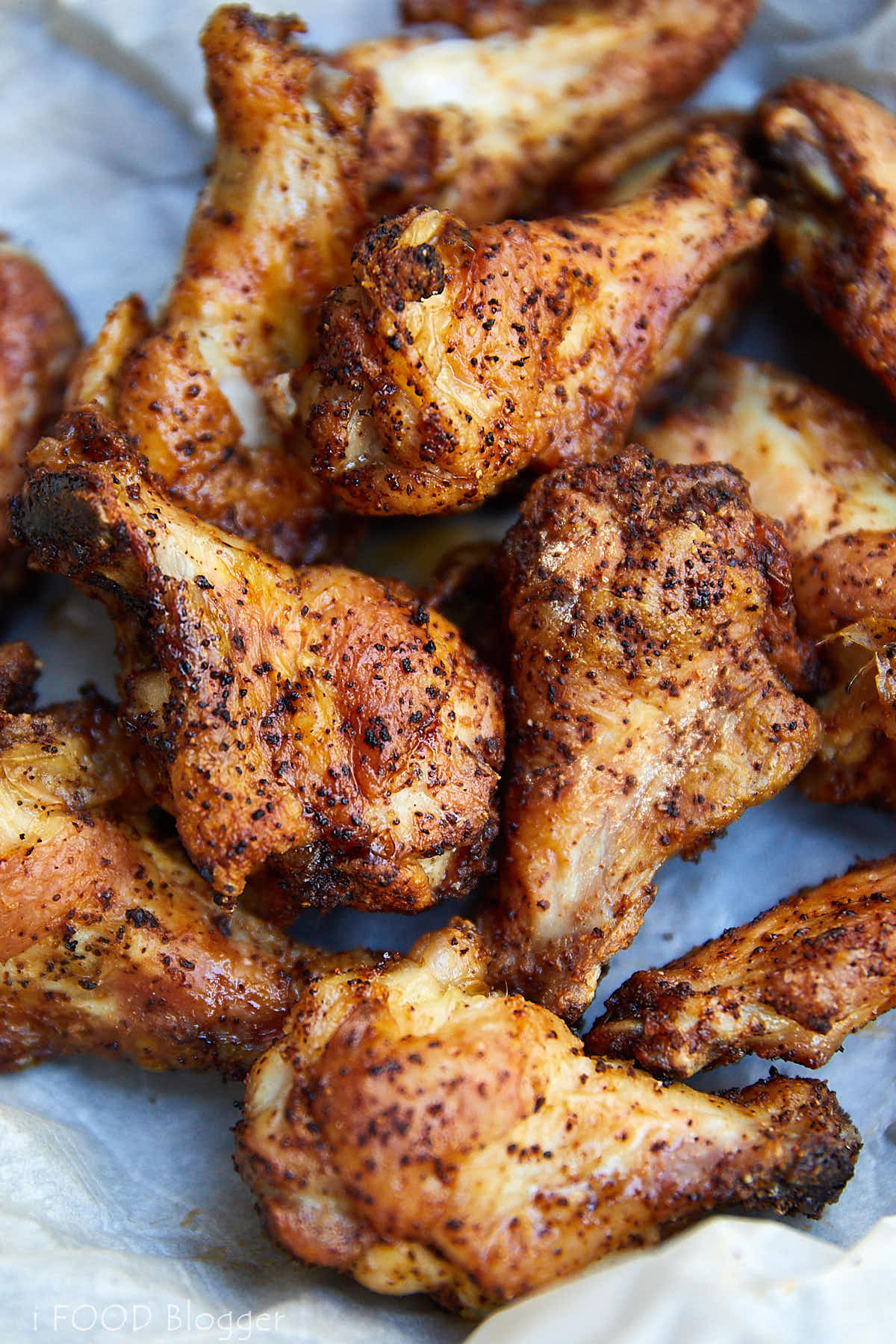 Close up view of a bunch of crispy, browned chicken wings.