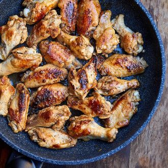 Learn how to fry chicken wings to make them super tender and flavorful. Try this recipe, you will love it. Chicken wings are first pan seared then cooked covered over low heat. All done in 30 minutes. | ifoodblogger.com