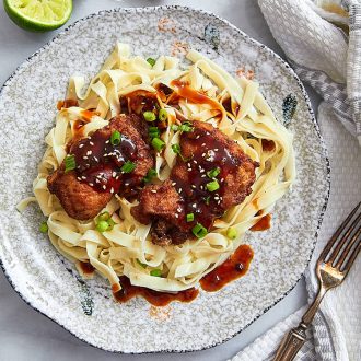 Boneless Skinless Chicken Thighs with Lime-Sesame BBQ Sauce - crispy fried chicken thighs served with a delicious BBQ sauce and a bowl of pasta. | ifoodblogger.com