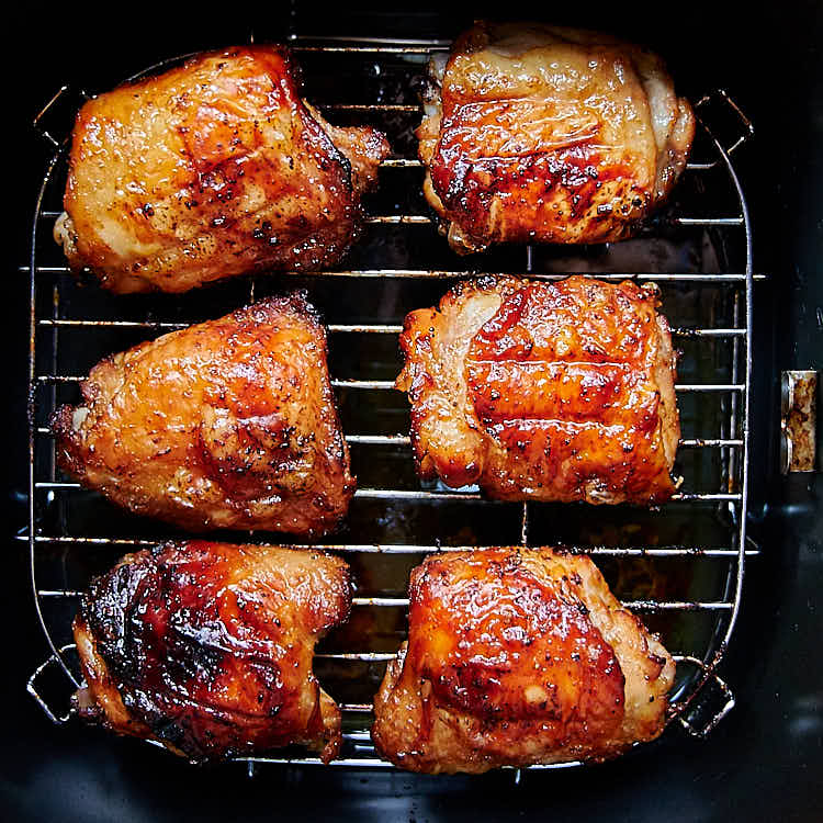 These air fryer chicken thighs are so good that you'll be making them again and again. Quickly marinated in a delicious Asian inspired sauce, they are slightly sweet from maple syrup with a hint of tartness from lime juice. They taste amazingly good! I guarantee you, these are some of the best chicken thighs you can make. They are a must try! Oh, and they only take about 30 minutes to make.| ifoodblogger.com