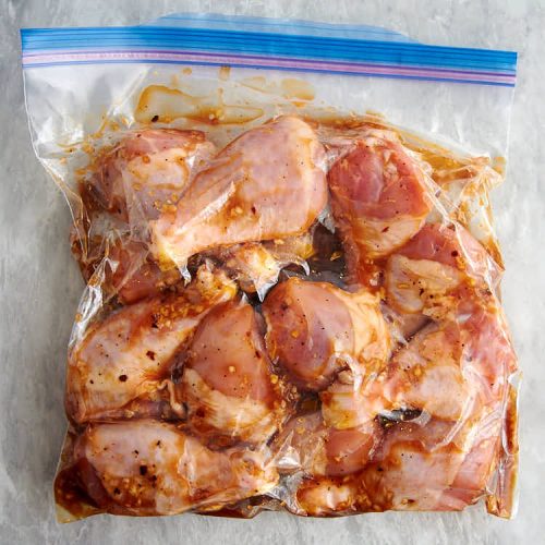 Chicken legs in a ziploc bag with marinade inside.