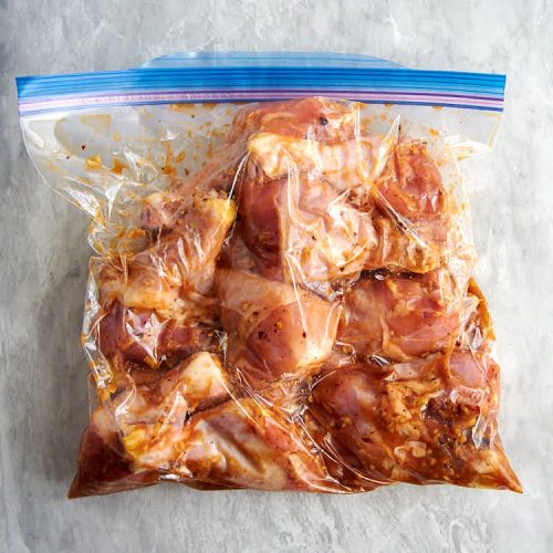 Chicken legs in a Ziploc bag with marinade, massaged for better marinade penetration.