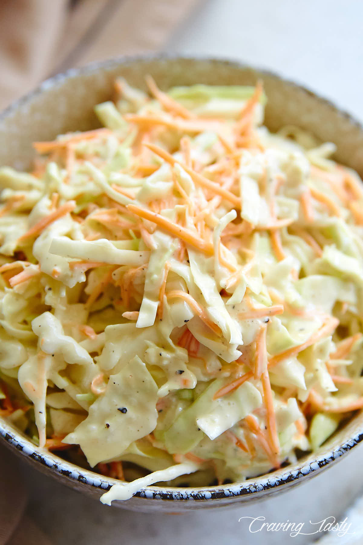 Top down close up view of a bowl filled with homemade coleslaw.