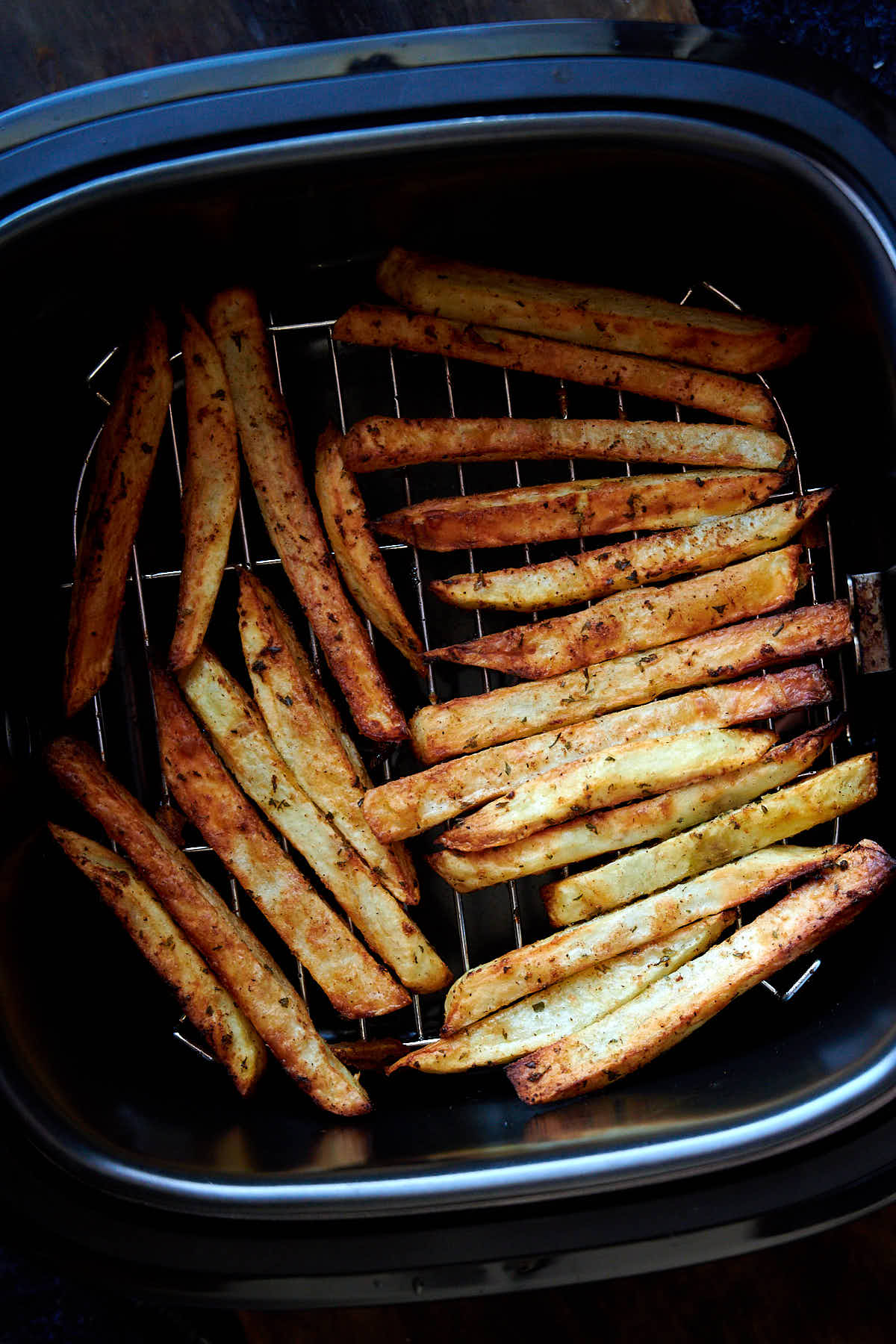 French fries inside an air fryer.