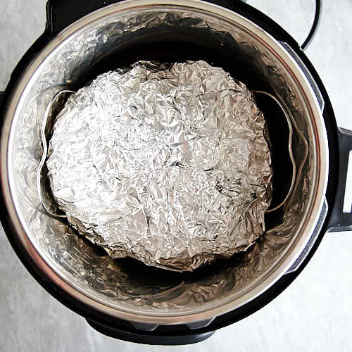 Pork butt, wrapped in foil, inside Instant Pot.