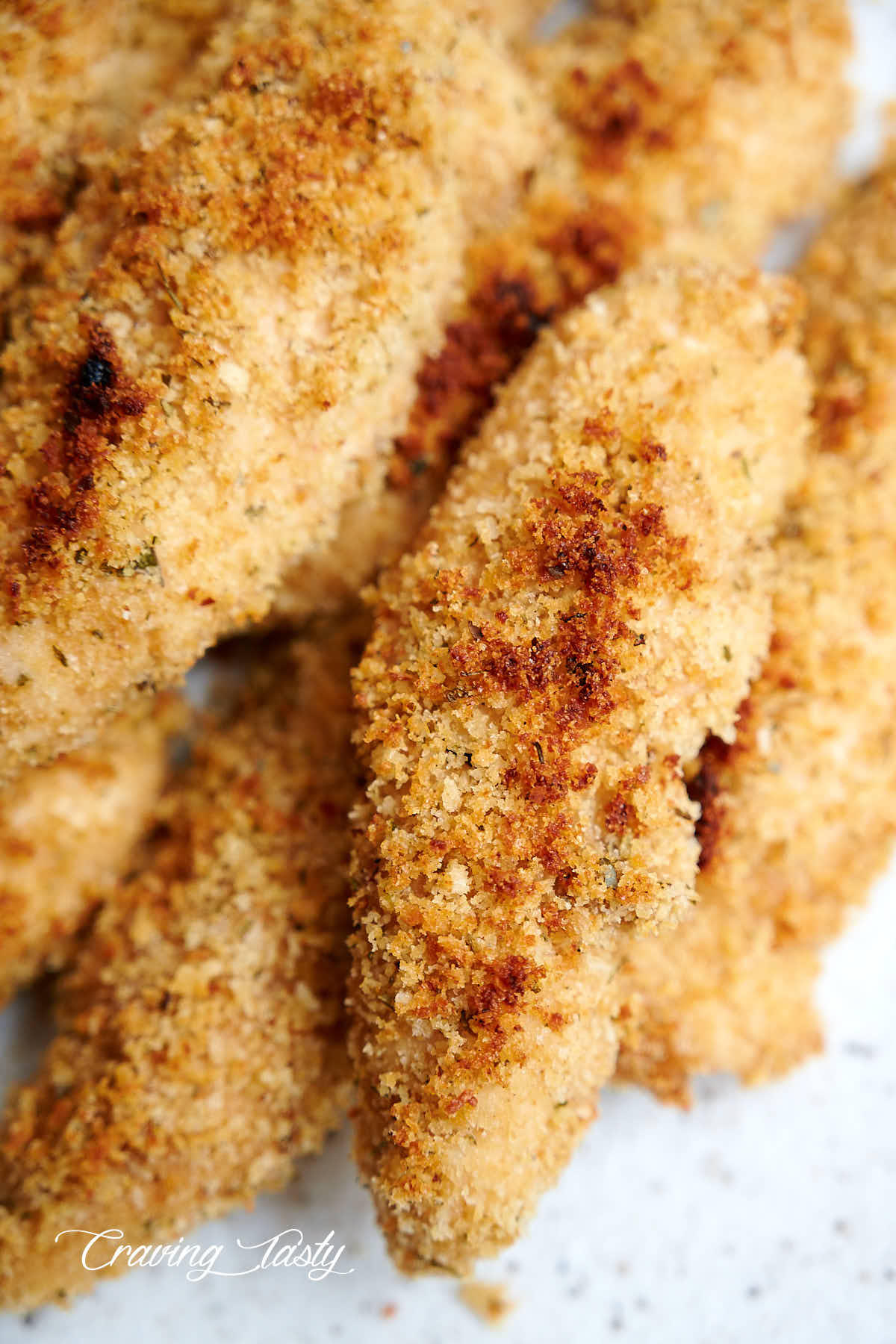 Close up of crispy, golden brown, breaded chicken tenders.