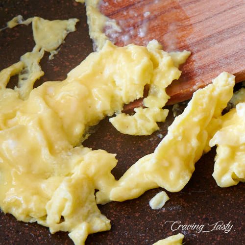 Soft scrambled egg on a pan.