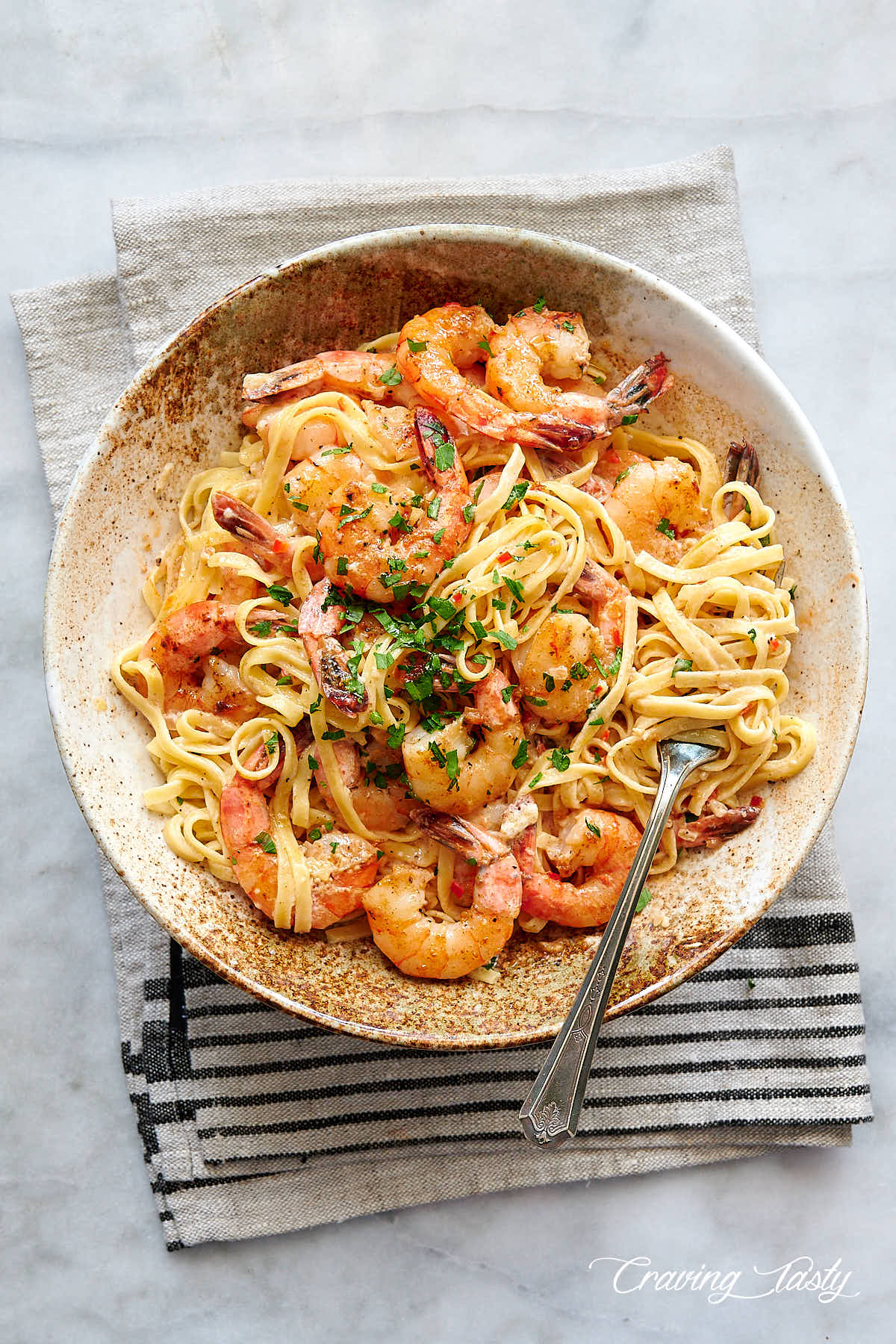 Creamy garlic butter shrimp with pasta in a bowl.