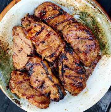 Grilled marinated pork chops on a platter