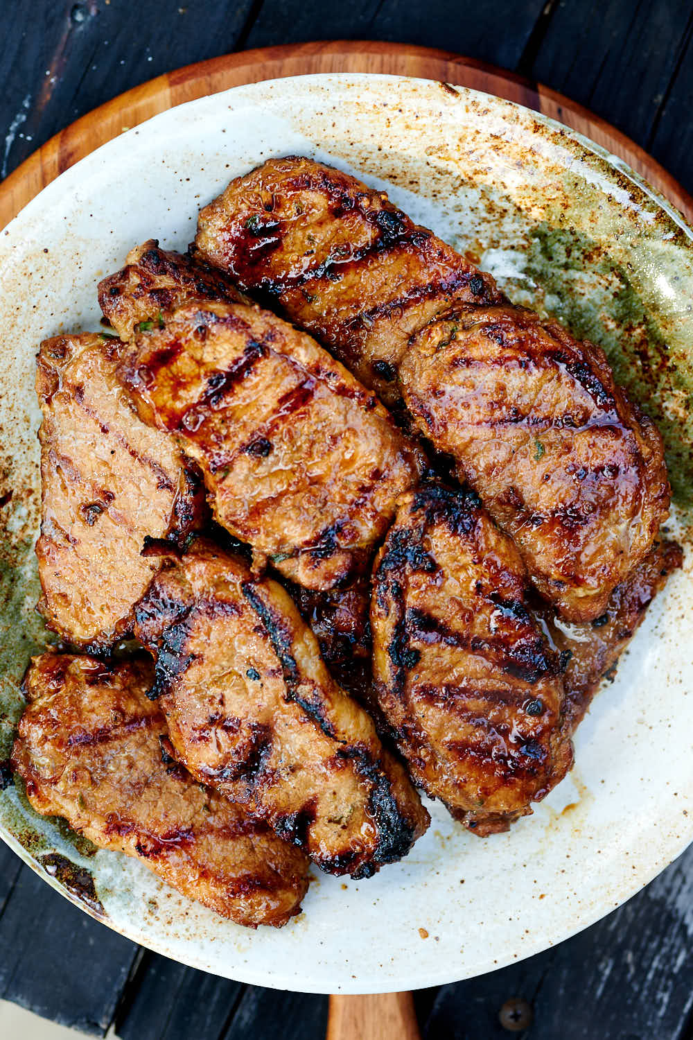 Grilled marinated pork chops on a platter