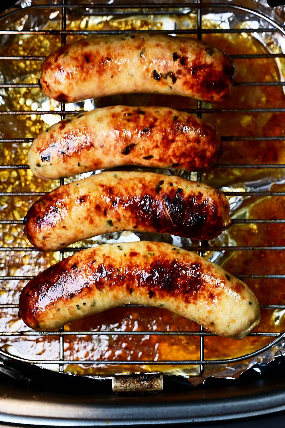 Golden brown air fried chicken sausage inside an air fryer
