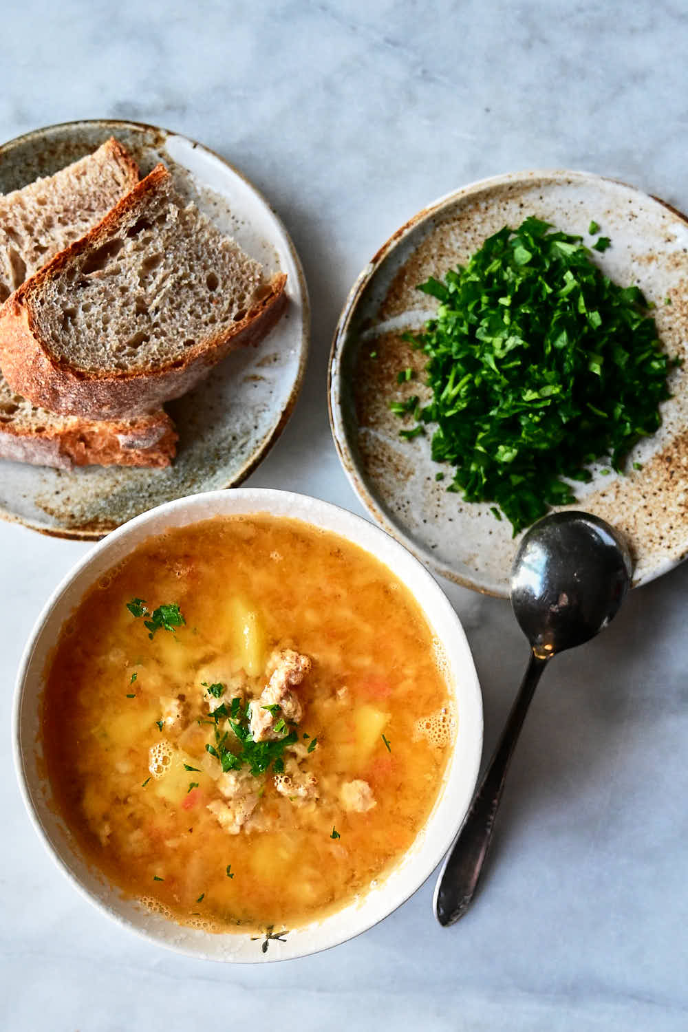 Chicken lentil soup with bread and chopped greens