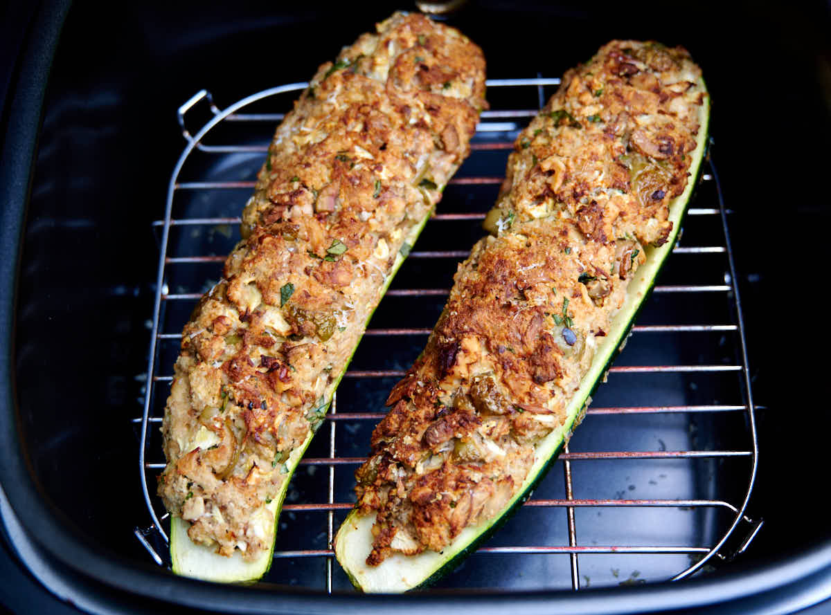 Fully done zucchini inside an air fryer.