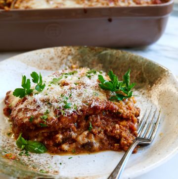 Eggplant parmesan made with slices of eggpant dipped in kefir batter, deep-fried and baked layered with meat sauce and cheese.